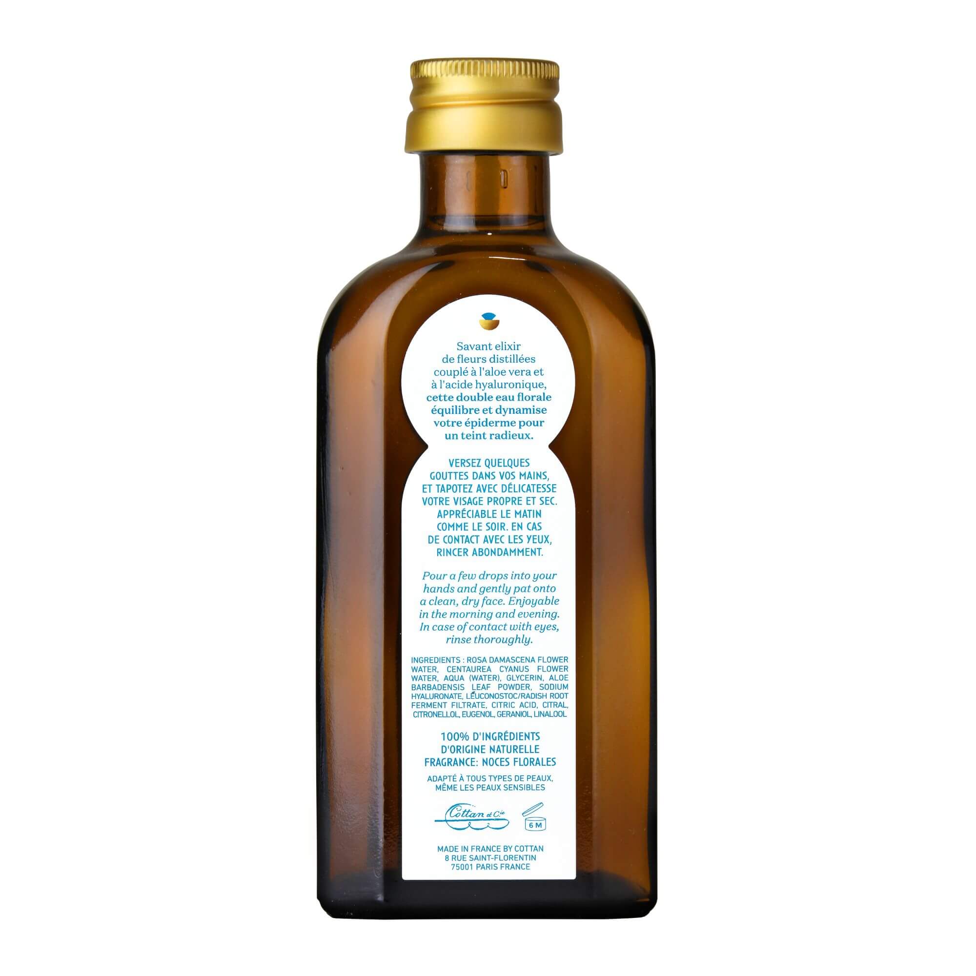 Vue arrière de la fiole de lotion florale Hydramisante COTTAN. L'arrière de la bouteille montre des informations supplémentaires sur le produit, y compris des détails sur l'utilisation et les bénéfices.
