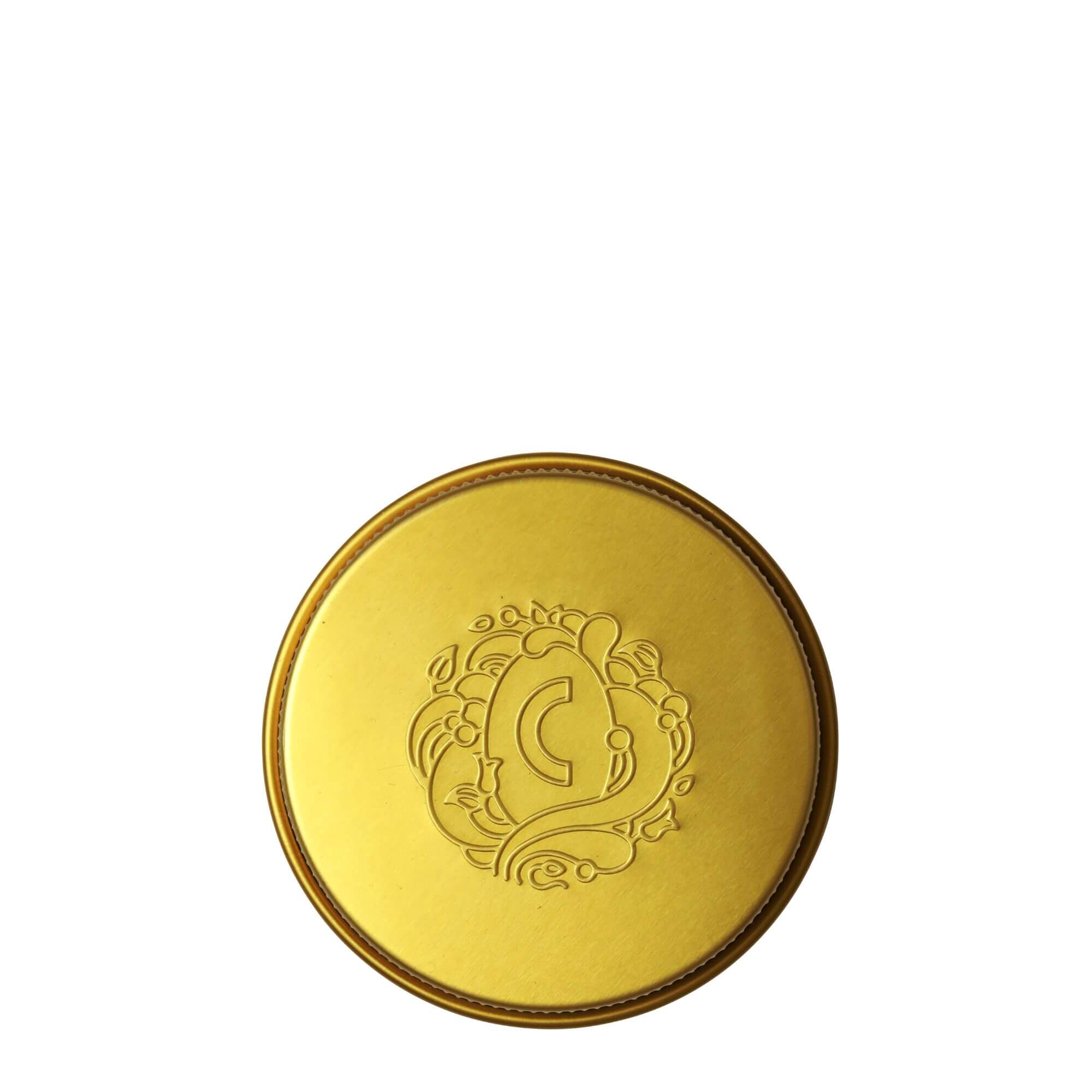 Close-up of the golden lid of COTTAN cleansing foam powder, highlighting its shiny finish and gold color.