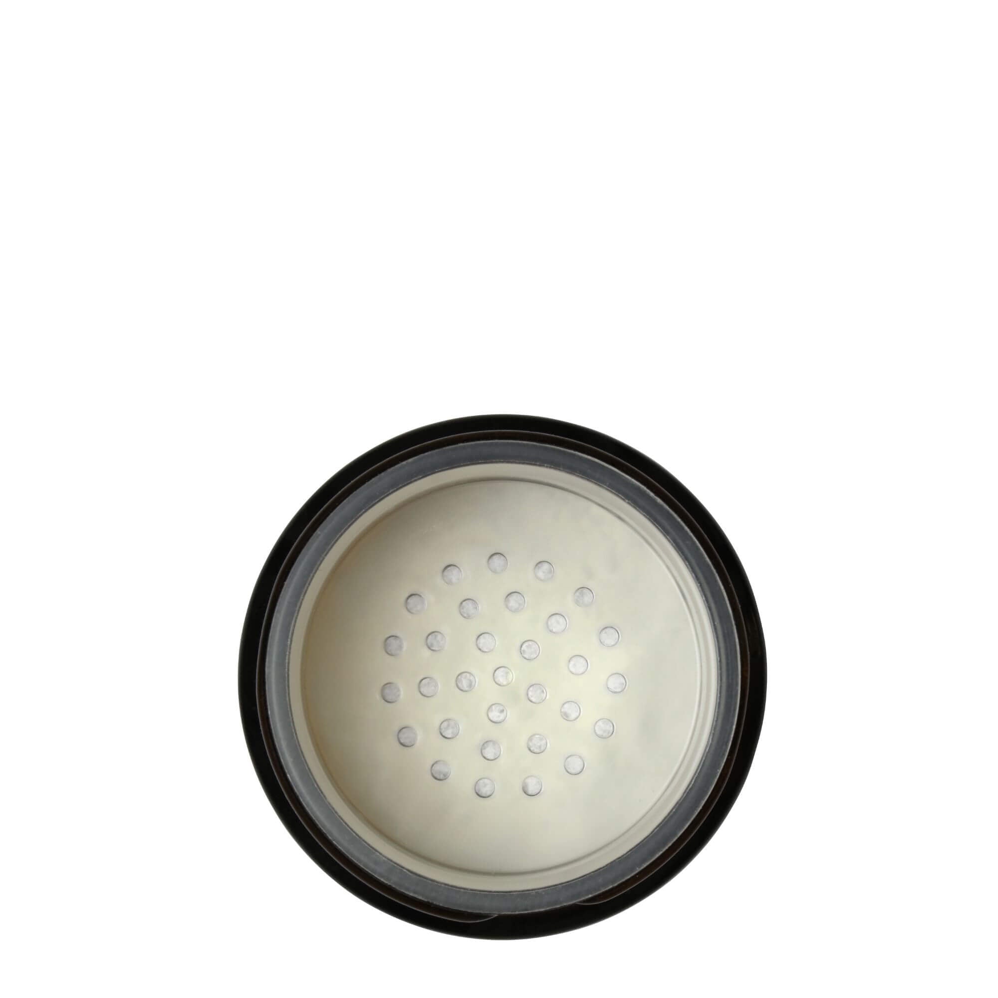 Close-up of the internal dispenser of COTTAN foaming powder cleanser, showing the dispensing holes and the mechanism for controlling the amount of product dispensed.