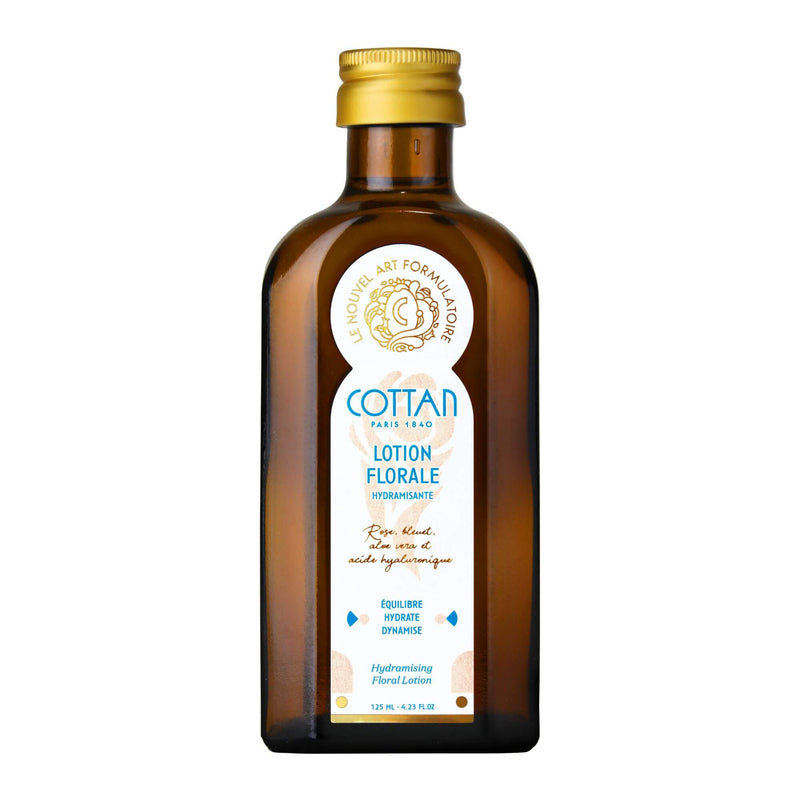 Vue de face de la fiole de lotion florale Hydramisante COTTAN sans son emballage. La bouteille de couleur brune transparente révèle le liquide à l'intérieur et l'étiquette frontale affiche le nom et la marque du produit.